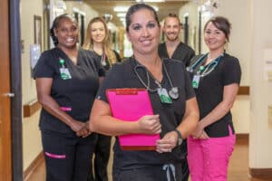 Copper Ridge staff smiling and standing in hallway