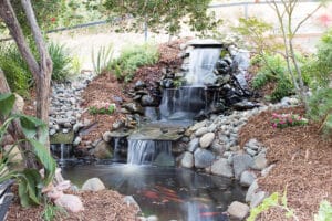 Beautiful three tiered waterfall with koi fishes