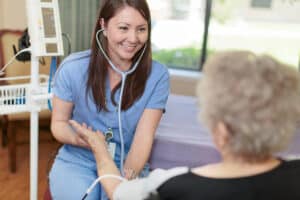 Nurse taking blood pressure of an elderly