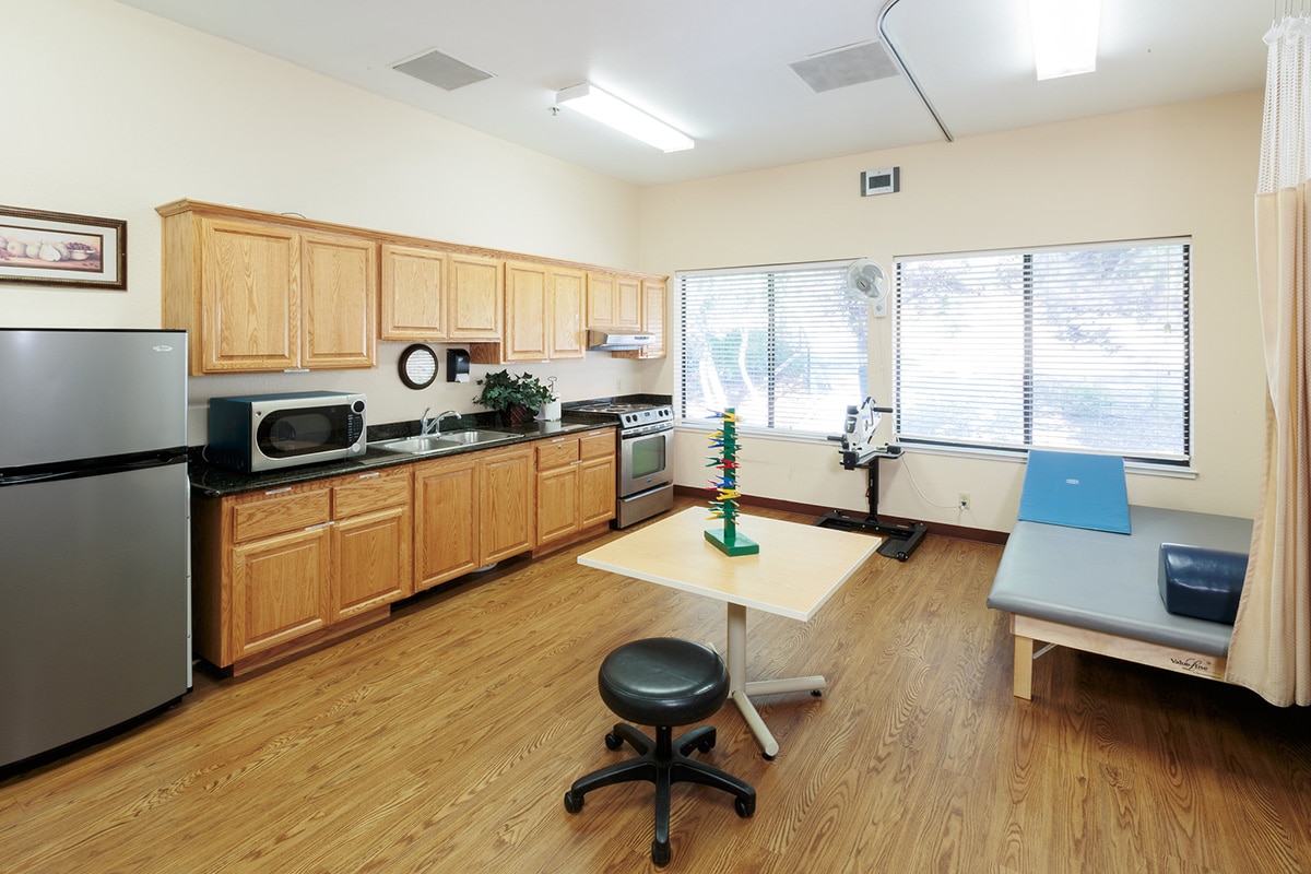 Small room with exercise equipments and kitchen