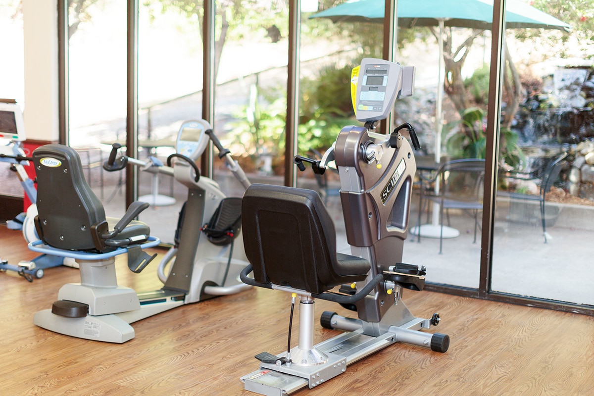 Room with exercise equipments facing waterfall