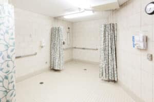 Spacious clean shower with hand rails