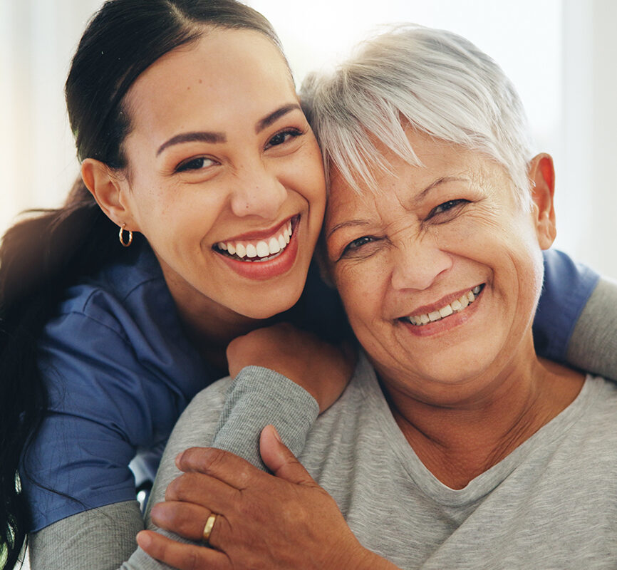 Happy woman, nurse and hug senior patient in elderly care, support or trust at old age home. Portrait of mature female person, doctor or medical caregiver hugging with smile for embrace at house